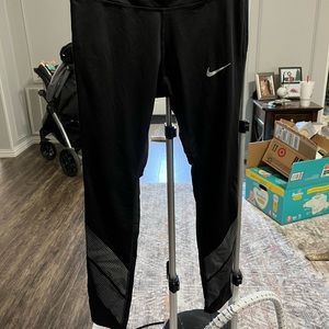 Black Nike running leggings with reflective stripes
